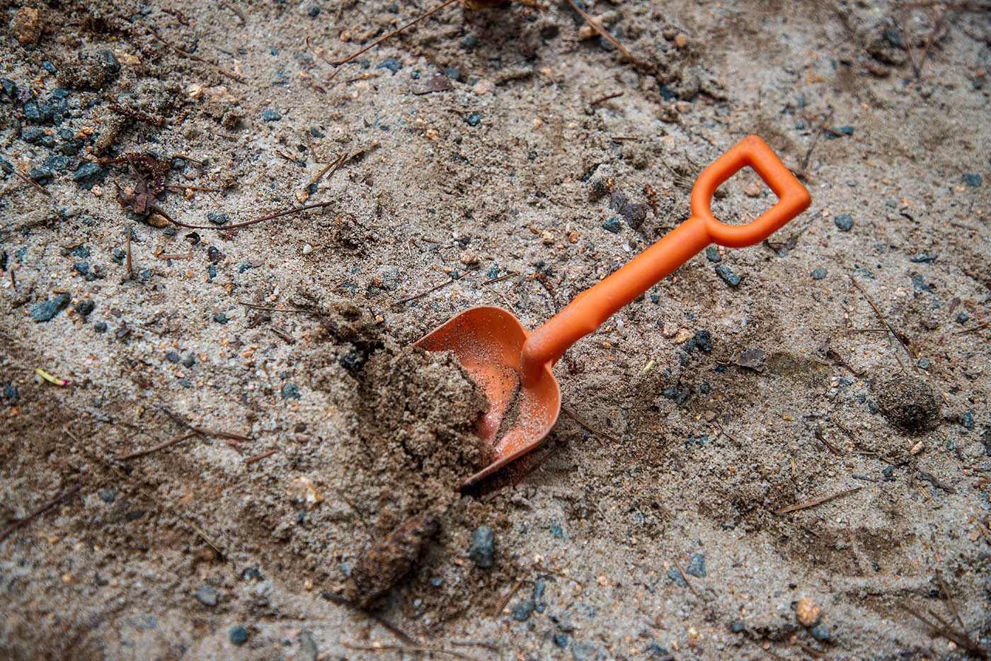 Orange toy shovel in the dig pit