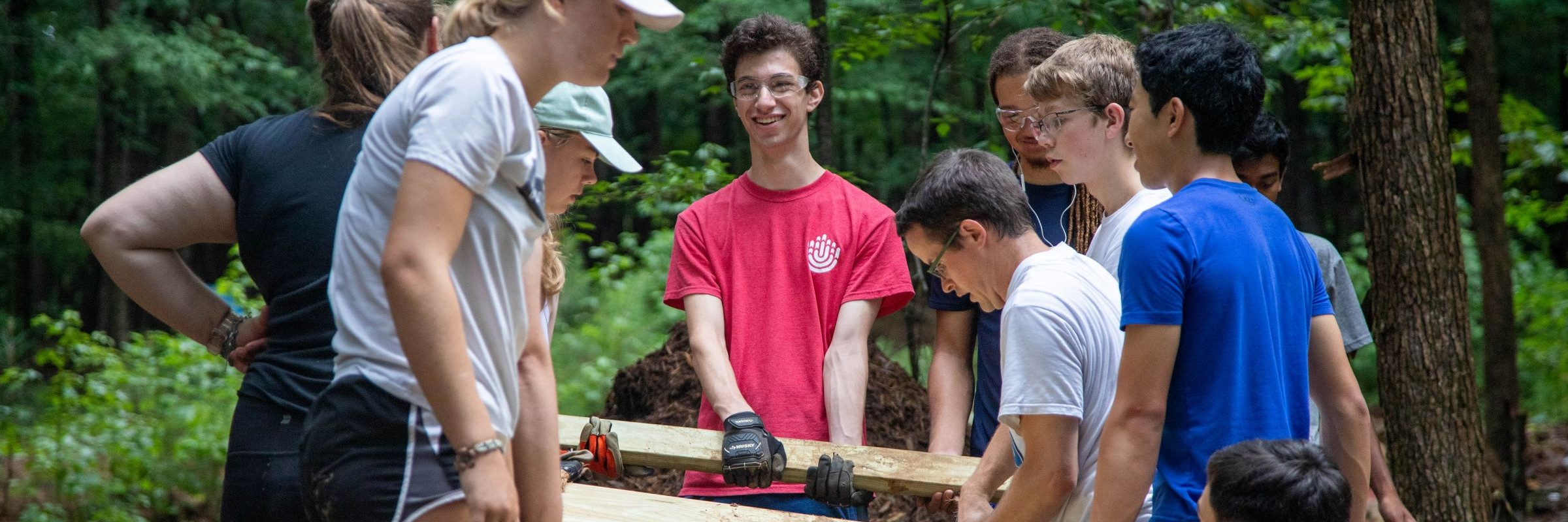 Group of teen park volunteers work on a building project