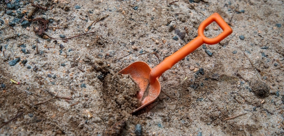 Orange toy shovel in the dig pit